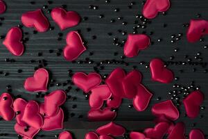 Red hearts on a dark background. photo