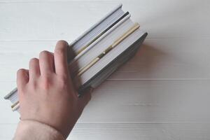 Books in the woman hand on the white background. photo