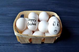 Eggs in a basket on the wooden vintage table. Happy Easter Day. Easter backgrund. photo