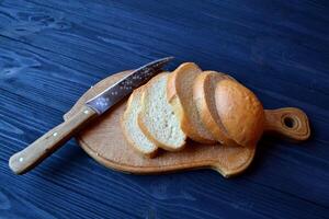 Sliced bread on a wooden table. photo