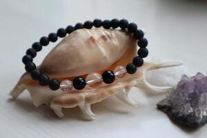 Bohemian bracelet from natural crystals on shell. Esoteric attribute. photo