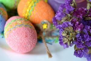 Colorful easter eggs with flowers in the plate. Beautiful easter background. Easter card. Homemade holiday decor. photo