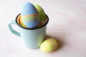 Easter egg in a cup. Beautiful easter background. Homemade holiday decor. photo