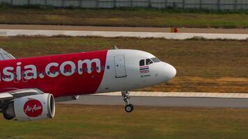 PHUKET, THAILAND - FEBRUARY 19, 2023 - Airbus A320-251N, HS-BBZ of AirAsia -MyMo by GSB Sticker- landing at Phuket airport. Low cost airline in Asia. Plane touching the runway, braking video