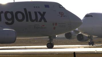 NOVOSIBIRSK, RUSSIAN FEDERATION - OCTOBER 20, 2021 - Wide-body cargo airliner Boeing 747 of Cargolux taxiing at Tolmachevo airport, middle shot, side view video