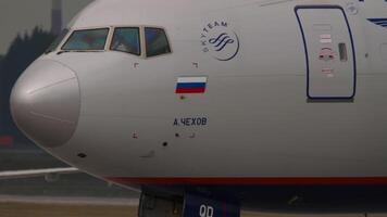 MOSCOW, RUSSIAN FEDERATION - JULY 29, 2021 - Wide-body passenger aircraft Boeing 777 Aeroflot Airlines taxiing, close-up, cockpit. The aircraft is named Anton Chekhov. Concept aviation video