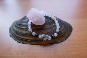 Rose quartz and bracelet from crystals on the natural shell. photo