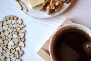 Morning coffee, tasty breakfast and decorative wooden hearts on the table. Hygge style background. photo