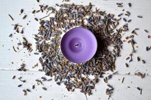 Lavender flavor. Violet candle in lavender flowers. Lavender aromatherapy. photo