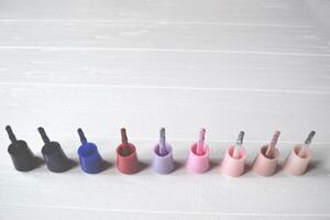 Palette of nail polish on the white wooden background with place for text. Manicure salon. photo