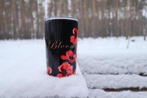 Thermal mug outdoor at snowy park. photo