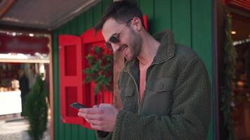 une homme dans une manteau parlant sur une cellule téléphone video