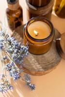 Soy candles in a glass jar. Aromatherapy. Burning candle and lavender. photo