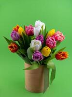 Bouquet of tulips. Flower delivery. Green background . Tulip. photo