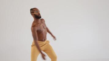 a man in a yellow pants dancing video