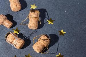 Champagne corks and metal mesh. Dark wine background photo