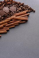 Food background. Coffee beans, cinnamon sticks and chocolate candies. photo