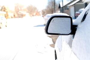 The white car is covered with pure white snow. At the winter time with snow strom. photo