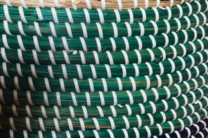 Green and white plastic weave texture pattern. texture of rattan mats, baskets or furniture. Abstract weave pattern background. photo