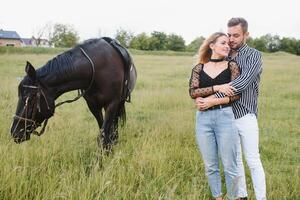 loving couple with horse on ranch photo