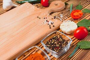 Composition with wooden board and ingredients for cooking on table photo