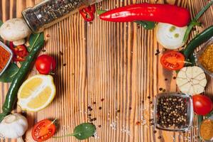 Cooking table. Background with spices and vegetables. Top view. Free space for your text. photo