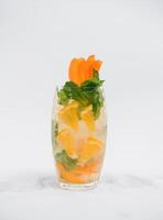 Glasse Of Drink With Ice Cubes And Fruits On White Background photo