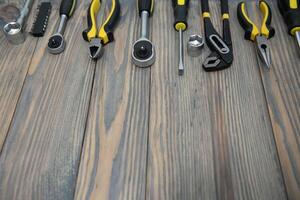 Various tools on wooden background photo