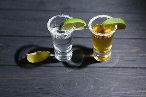 Mexican tequila with lime and salt on rustic wood background. space for text. concept luxury drink. Alcoholic drink concept. photo