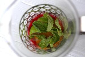 Ingredients for cooking natural tea. Mint, lime and raspberry jam on the white wooden table. photo