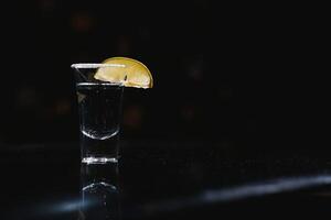 tequila with lime on a dark background photo