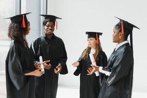 portrait of multiracial graduates holding diploma photo