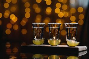 tequila with lime on a dark background photo