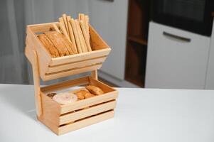 Craft wooden plate for storing bread or vegetables in the kitchen photo