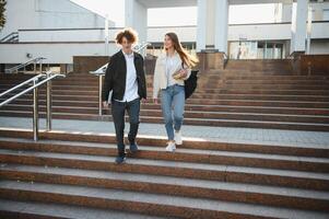 Education, campus, friendship and people concept. Group of happy students outdoor photo