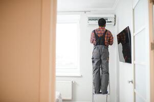 AC Electrician Technician Repairing Air Conditioner Appliance photo
