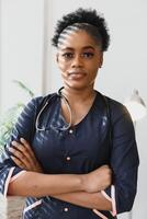 An African American female medical doctor with a stethoscope in hospital. photo