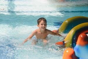 The boy is rolling with a water slide at a water park in Little Rock photo