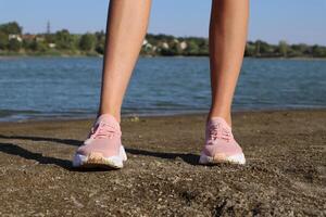 Female legs in pink sneakers, outdoor. photo