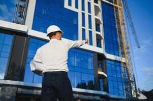 portrait of a young architect or engineer on a construction site photo