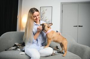 Young woman with her cute dog at home. Lovely pet photo