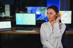 Smiling friendly female call center agent with headset working on support hotline in the office photo