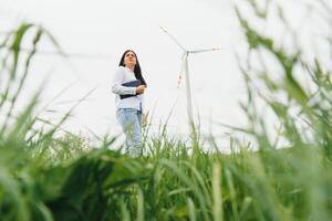 Female Engineer in a Wind Turbines Farm photo