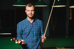 Man playing billiards in a club photo