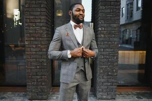 Portrait of an African American businessman wearing a suit standing in an outdoor business environment photo