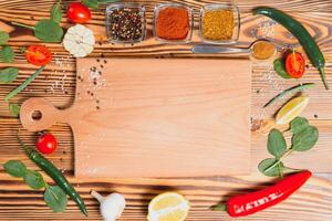 Cooking table. Background with spices and vegetables. Top view. Free space for your text. photo