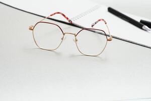 notebook, glasses, pen on a white background top view, school, education, knowledge photo