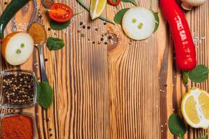 Cooking table. Background with spices and vegetables. Top view. Free space for your text. photo