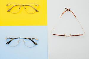 Stylish eyeglasses. Modern eyeglass frames on a colored background photo