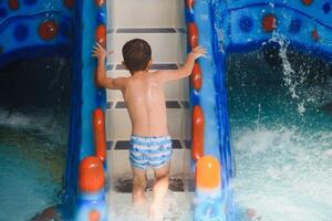 Boy having fun in aqua park photo